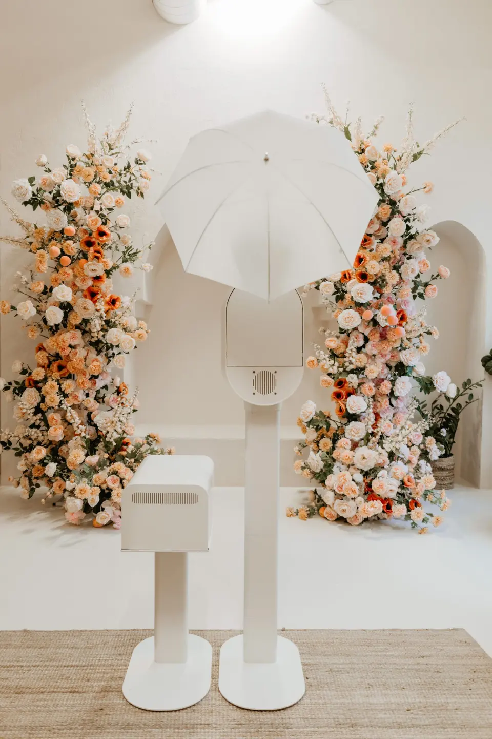 White photo booth with a floral arch